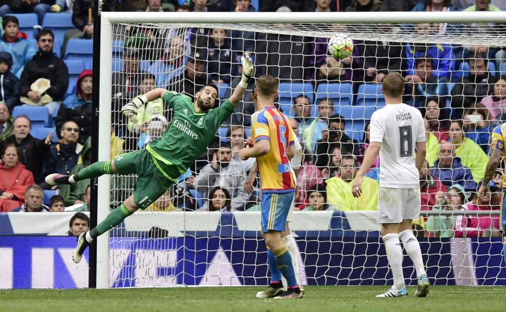 Real Madrid's goalkeeper Francisco Casilla (L) tries to stop a ball during the Spanish league football match Real Madrid CF vs Valencia CF at the Santiago Bernabeu stadium in Madrid on May 8, 2016. / AFP PHOTO / JAVIER SORIANO